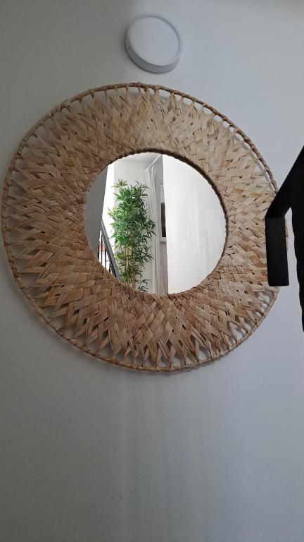 a mirror on a wall with a person taking a picture at Novalja centar in Novalja