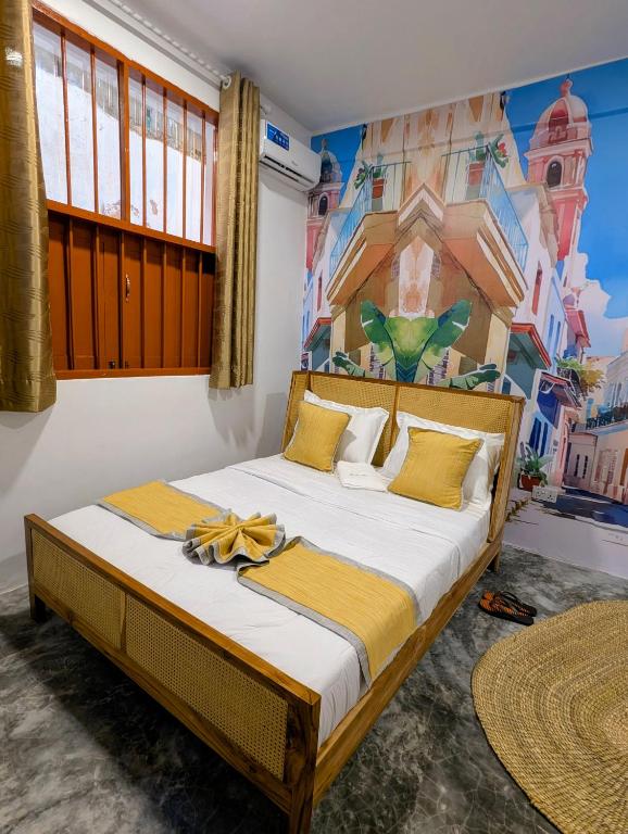 a bedroom with a bed with a painting on the wall at Bellimena Stone Town in Zanzibar City