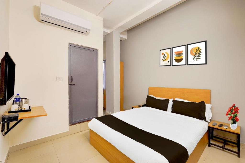una camera da letto con un letto, una scrivania e una finestra di Super Townhouse Nanganallur Near Chennai Airport a Chennai