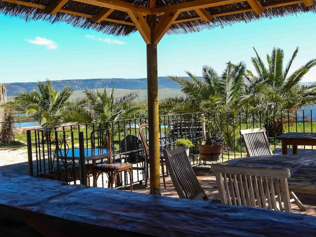 a table and chairs with a view of the ocean at Casa Entre Armonías in Zahara de los Atunes