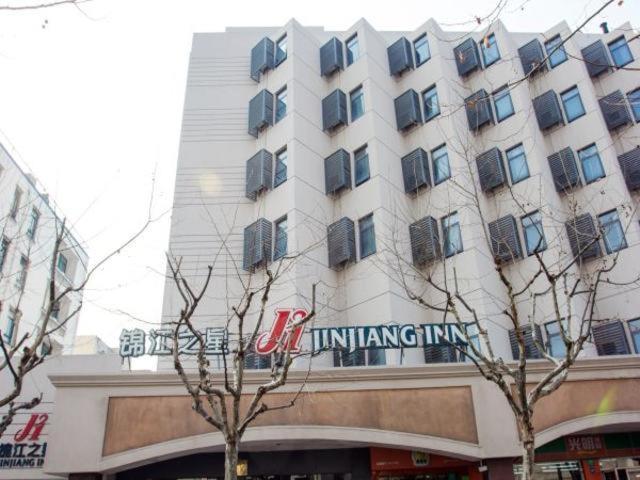 a large white building with a sign on it at Jinjiang Inn Shanghai Expo Area Licheng Road in Shanghai