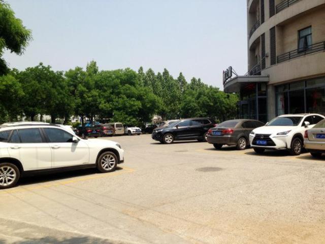 BaodingにあるJinjiang Inn Baoding Military School Squareの駐車場に停車した車の集団