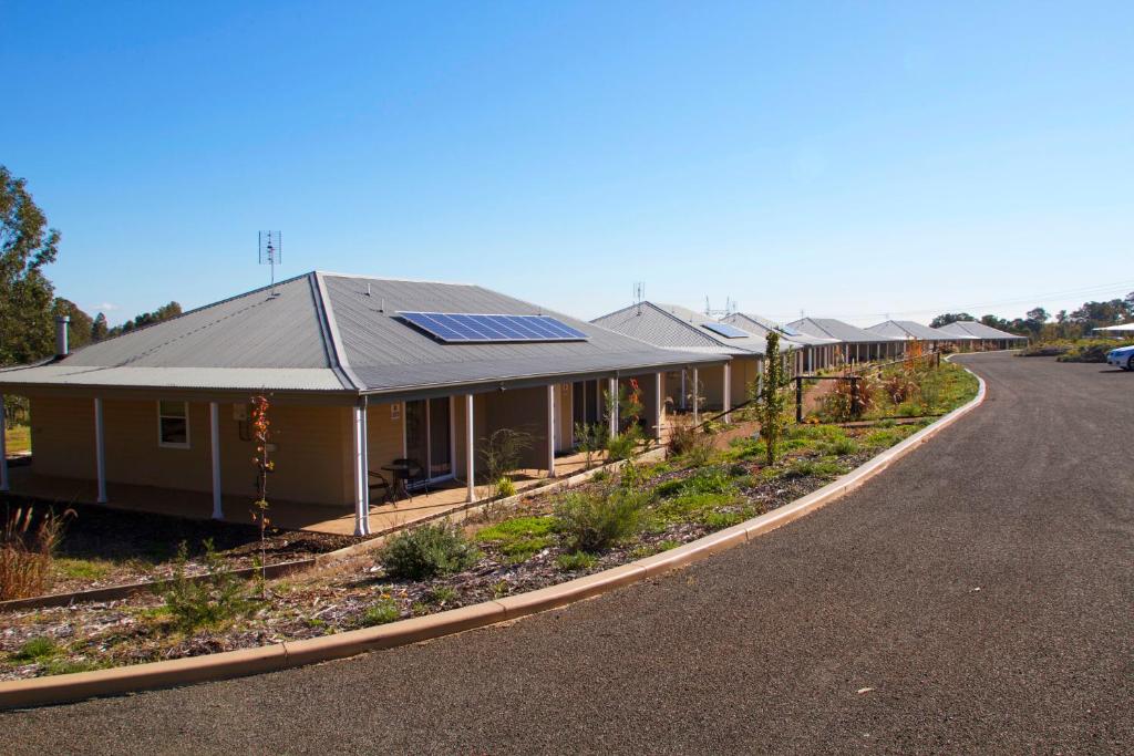 a row of houses with solar panels on the side of the road at H Boutique Hotel in Pokolbin