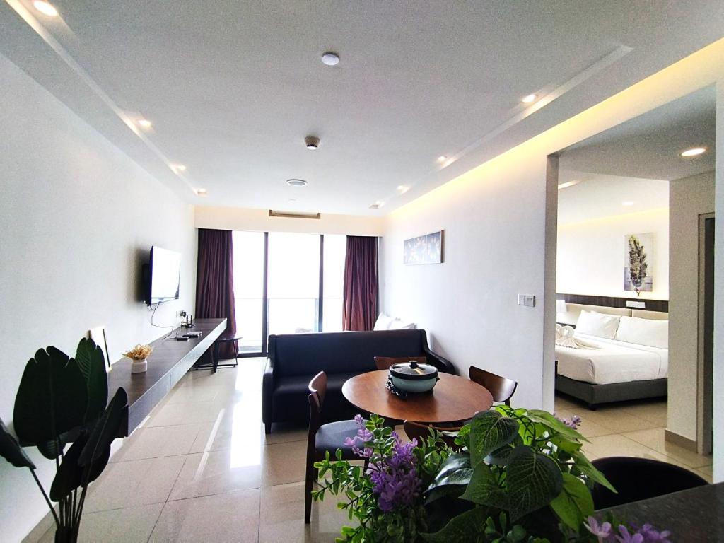 a living room with a couch and a table at Genting SmokyColdInn1R1B AT Ion Delemen in Genting Highlands