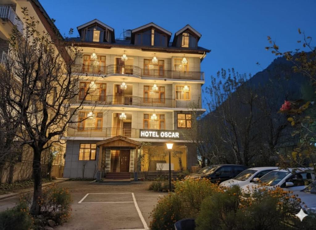 a large building with a sign that reads hotel system at Hotel oscar Mountain Retreat in Manāli