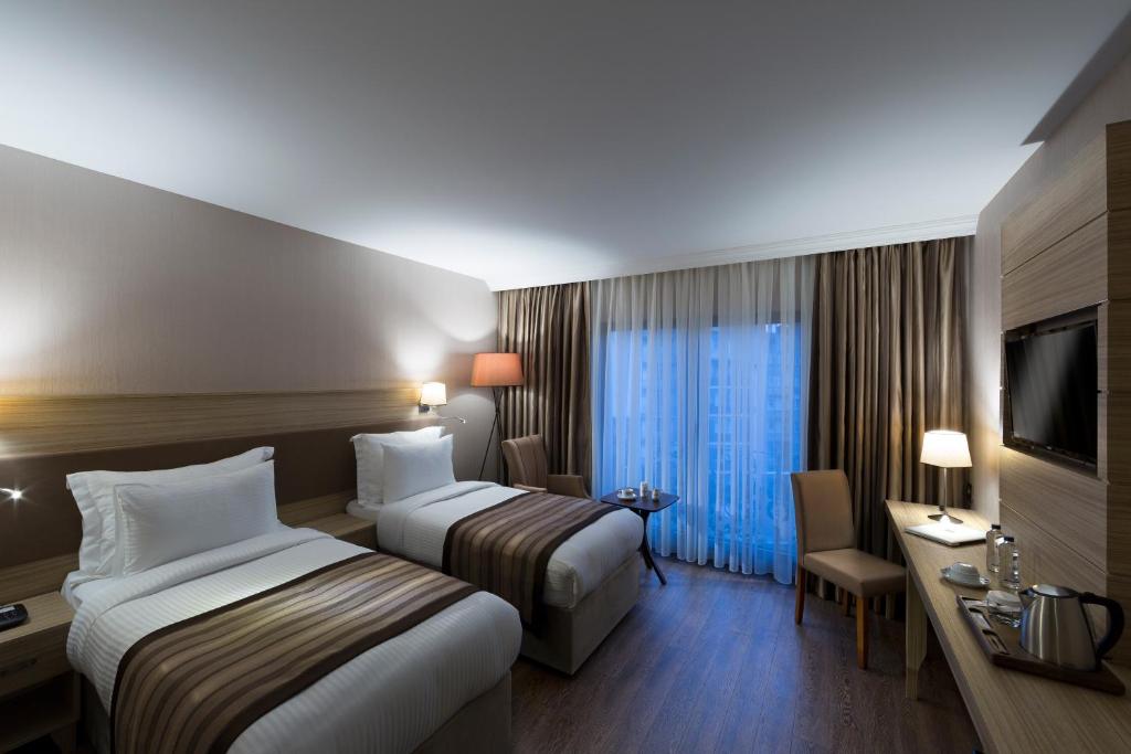 Кровать или кровати в номере Regard Hotel