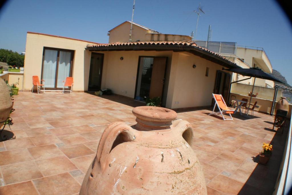 a vase sitting on a patio in front of a house at Valverde Penthouse in Sciacca