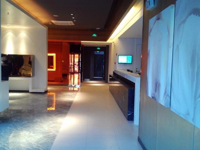 a hallway of a building with a kitchen and a counter at Jinjiang Inn Select Nanjing South Railway Station North Square in Nanjing