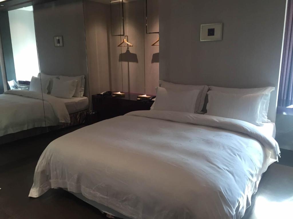 Postel nebo postele na pokoji v ubytování All-Ur Boutique Motel - Xinzhuang Branch