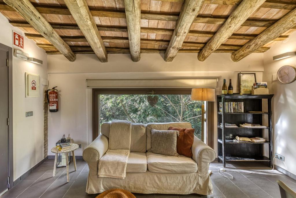 a living room with a couch and a window at La Pallissa - Can Bonet in Sant Martí Vell