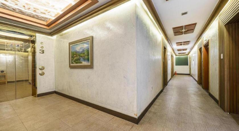 a hallway in a building with a painting on the wall at Yongin Valentine in Tansa-gol
