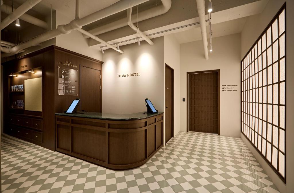 a lobby with a reception desk in a building at Kiwa Hostel in Seoul