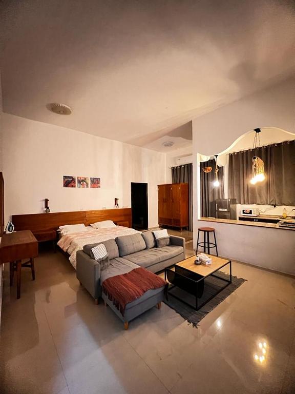a large living room with a bed and a couch at Cozy studio AlJimi in Al Ain