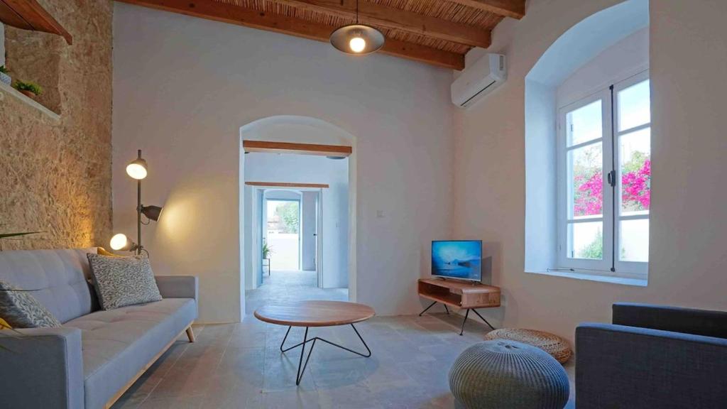a living room with a couch and a table at stonebuilt HiddenHouse in Paphos