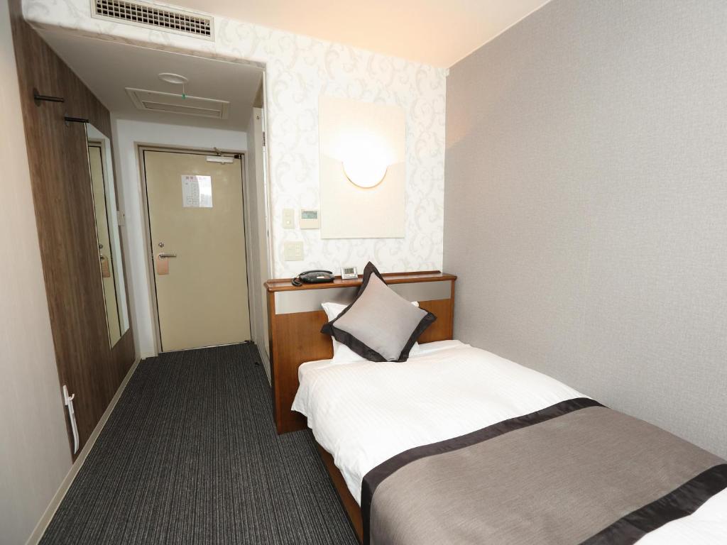 Postel nebo postele na pokoji v ubytování Hotel Areaone Kochi
