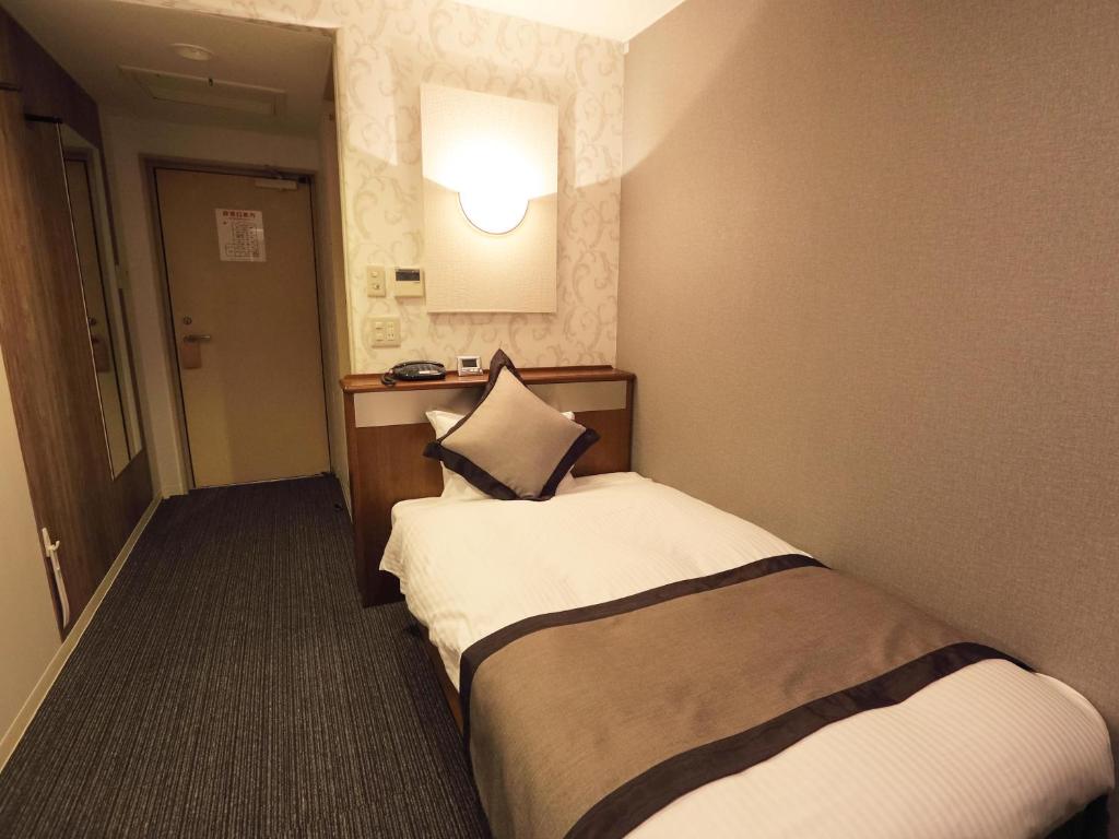 Postel nebo postele na pokoji v ubytování Hotel Areaone Kochi