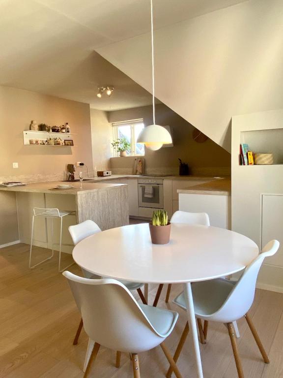 a kitchen and dining room with a white table and chairs at Central Apartment Stavanger 2 Bedroom Sleeps 4 in Stavanger