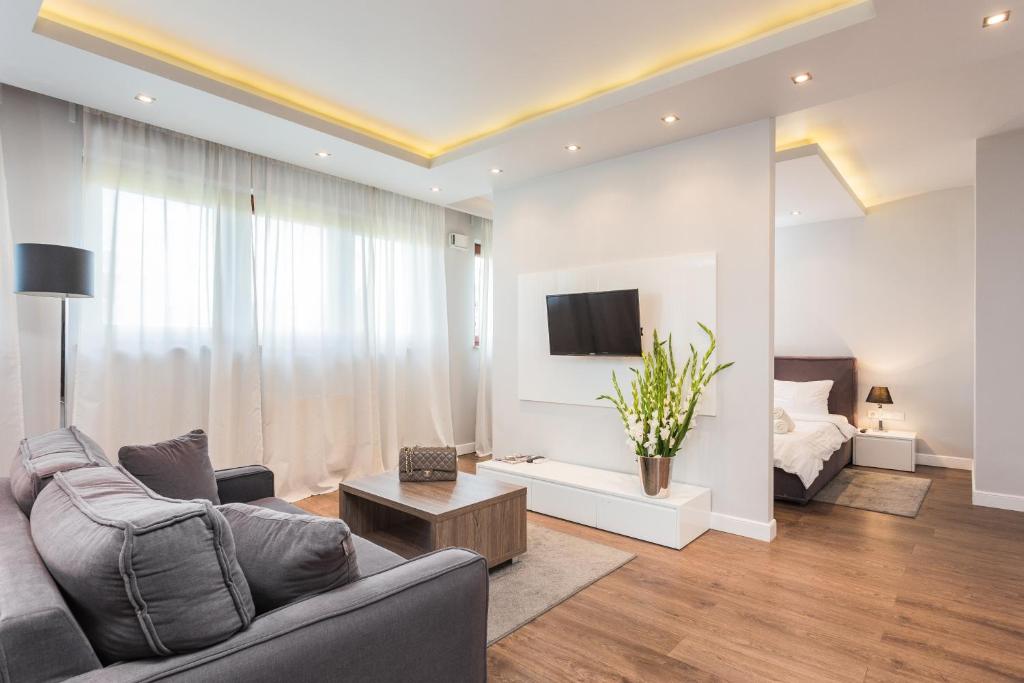 a living room with a couch and a tv at Oxygen Residence in Warsaw