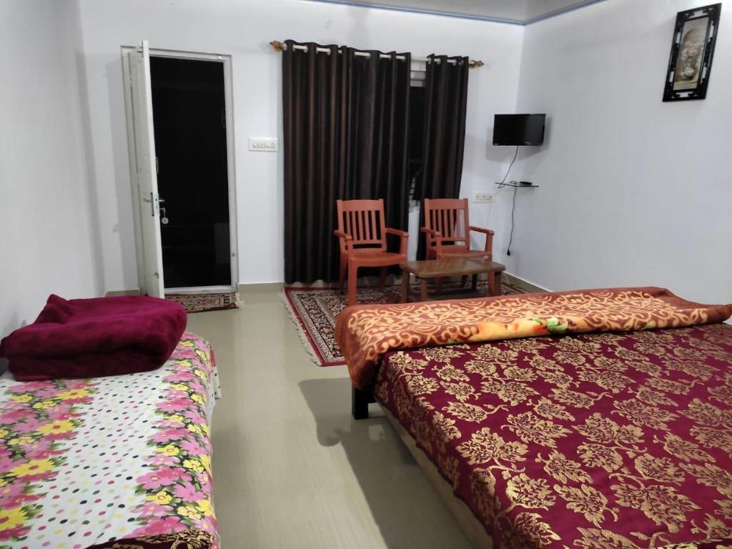 a bedroom with two beds and a table and a chair at South point in Ammatti