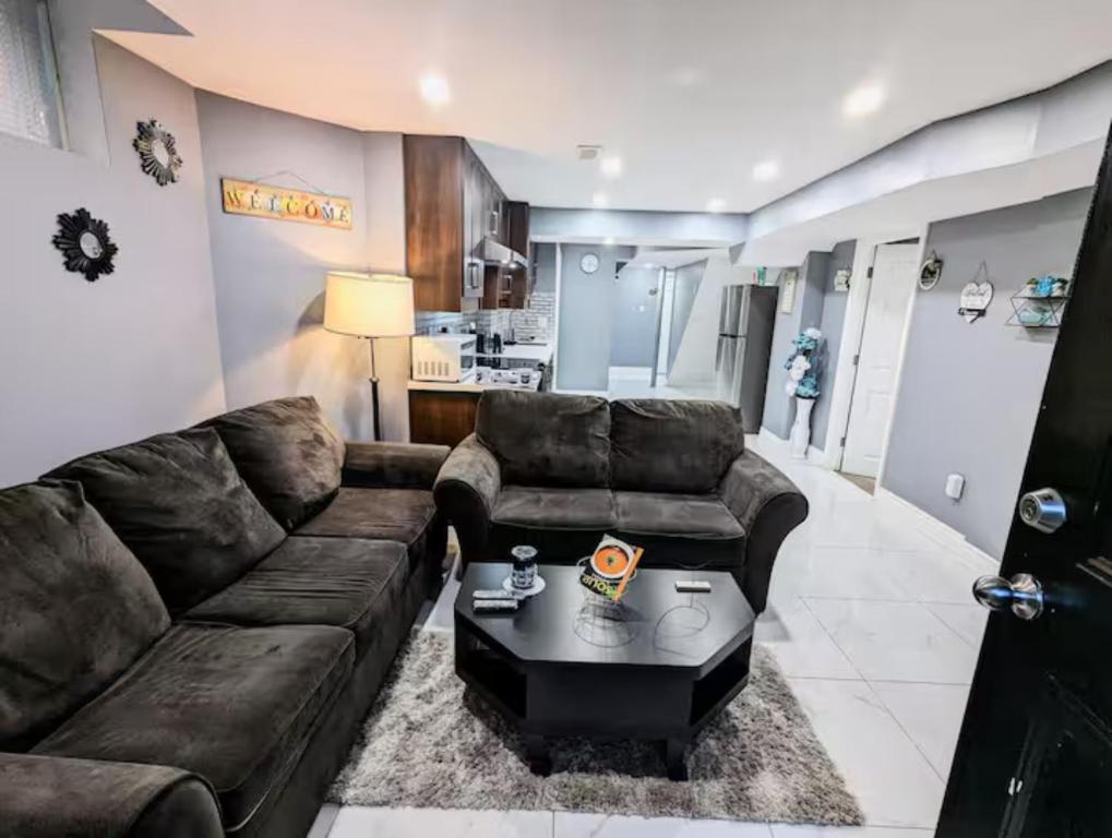 a living room with a couch and a coffee table at Stunning-Luxury-Cozy Private Suite In Ajax in Ajax