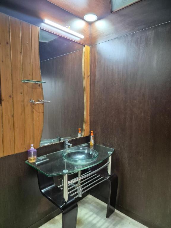a bathroom with a sink and a mirror at Charu's Villa By Elite Stays in Jāmb