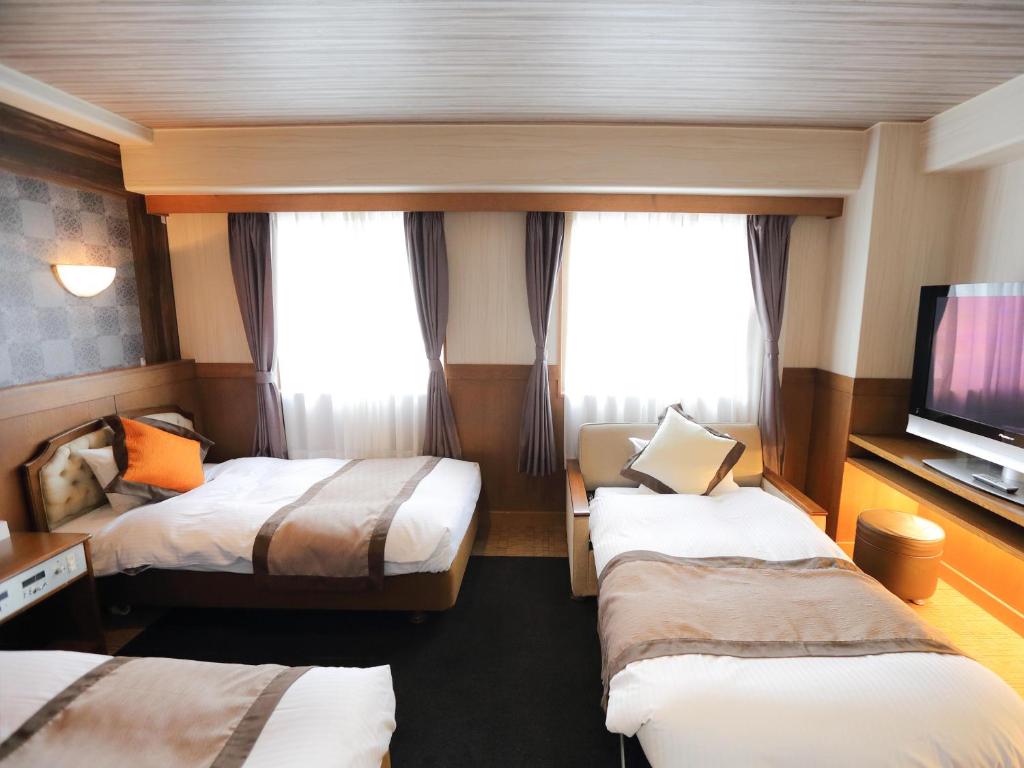 Postel nebo postele na pokoji v ubytování Hotel Areaone Kochi