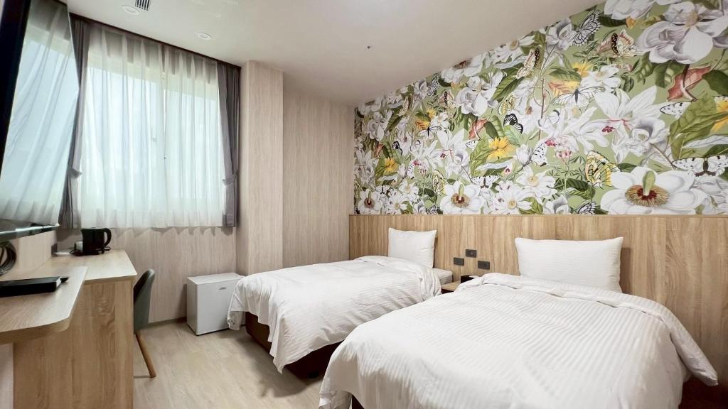 Ένα ή περισσότερα κρεβάτια σε δωμάτιο στο 星 雨 行 館 - 逢 甲 洲 際 館