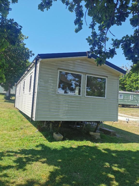 a tiny house sitting on top of a field at Thornesbay holiday park in Isle of Wight