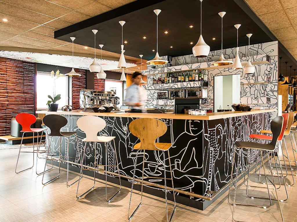 um bar com uma parede estampada em preto e branco em Ibis Milano Fiera em Lainate