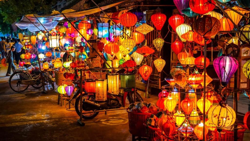 a display of lanterns and lights in a market at Cala Hotel in Hoi An