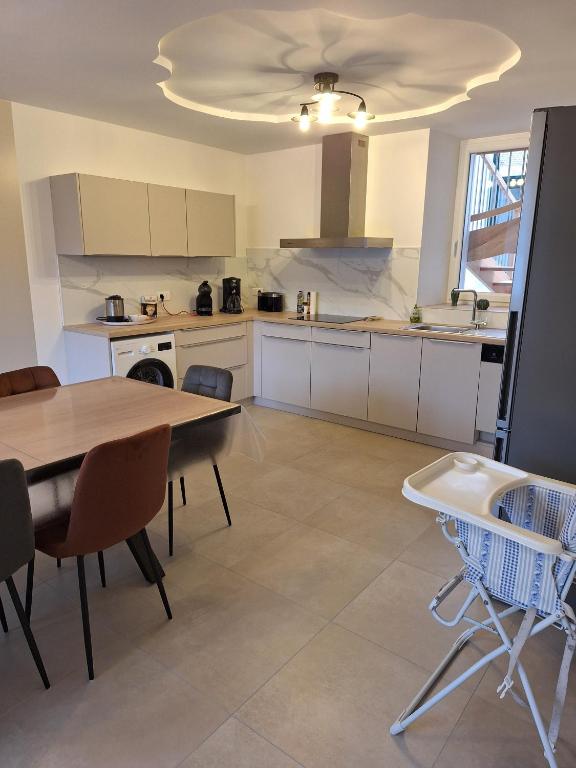a large kitchen with a table and chairs in it at Gite en Champagne in Vertus