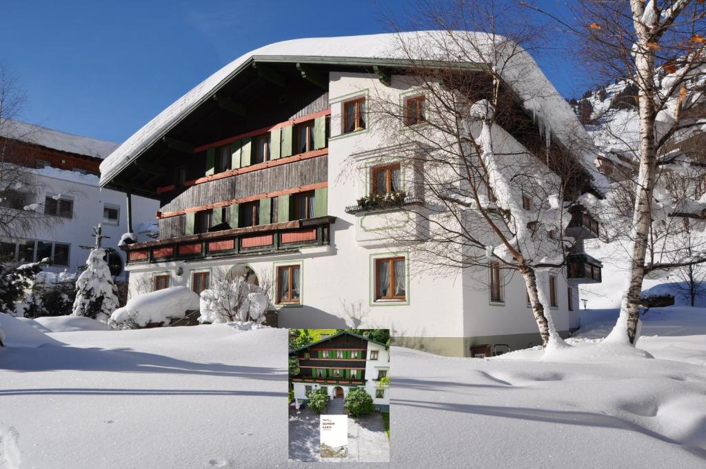 a building with snow on the ground in front of it at Haus Gamberg in Sankt Anton am Arlberg