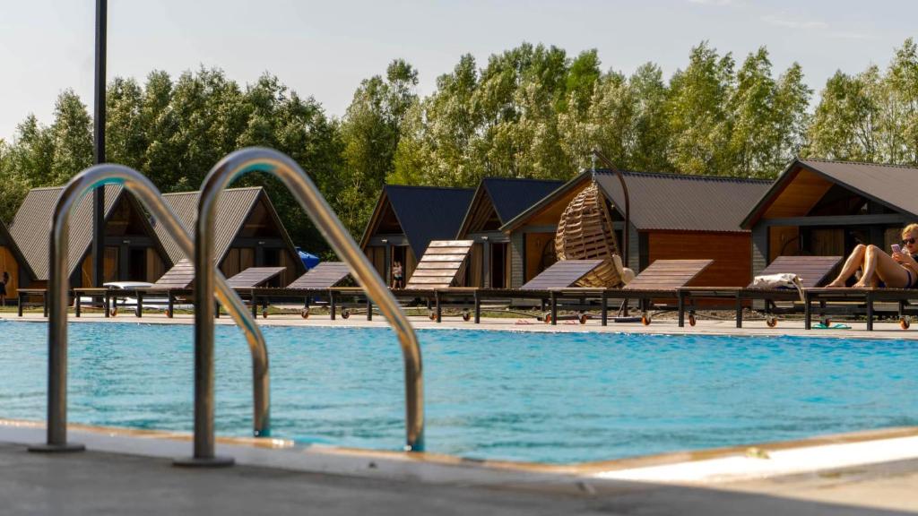 a swimming pool with some chairs and a swimming pool at Ranch in Variani in Variani