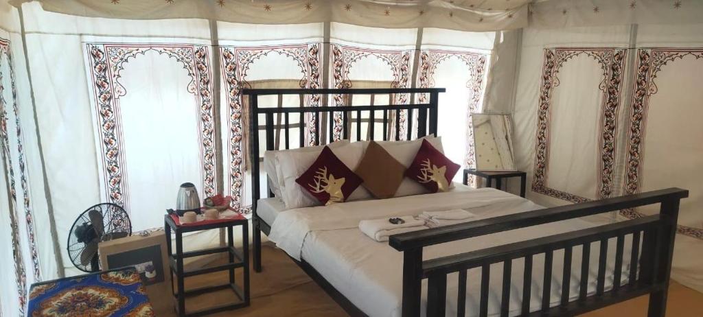 a bedroom with a large bed in a room at Mehta Desert camp Sam sand Dunes Jaisalmer in Jāmb
