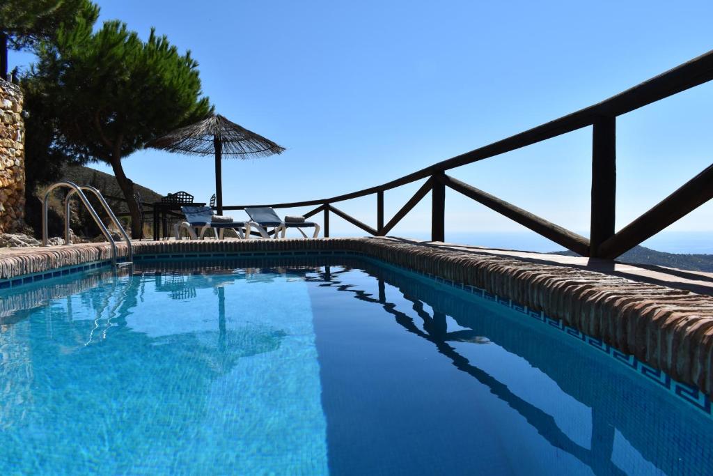 a swimming pool with a view of the ocean at Finca La Sierra with private Pool in Cómpeta