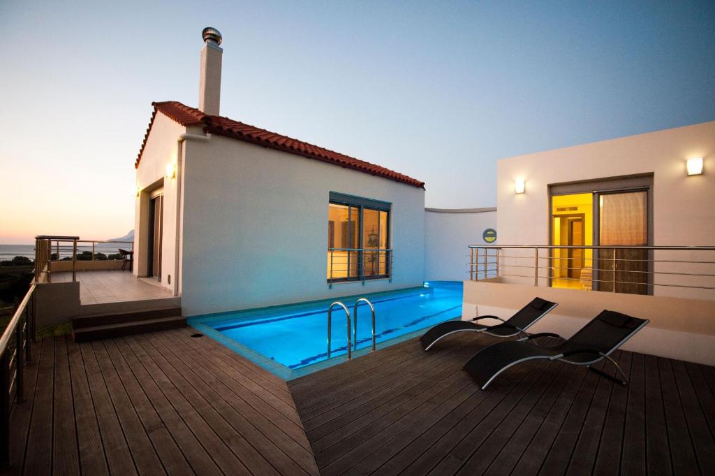 a house with a swimming pool on a deck at Villa Levantes Ferienhaus In Mithimna Mit Pool in Kissamos