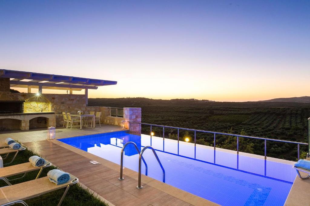 a villa with a swimming pool with a view at Kampos Villa 1 in Achlades