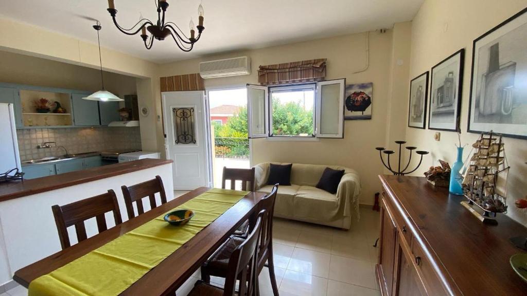 a kitchen and living room with a table and a dining room at Suli Residences in Pesádha