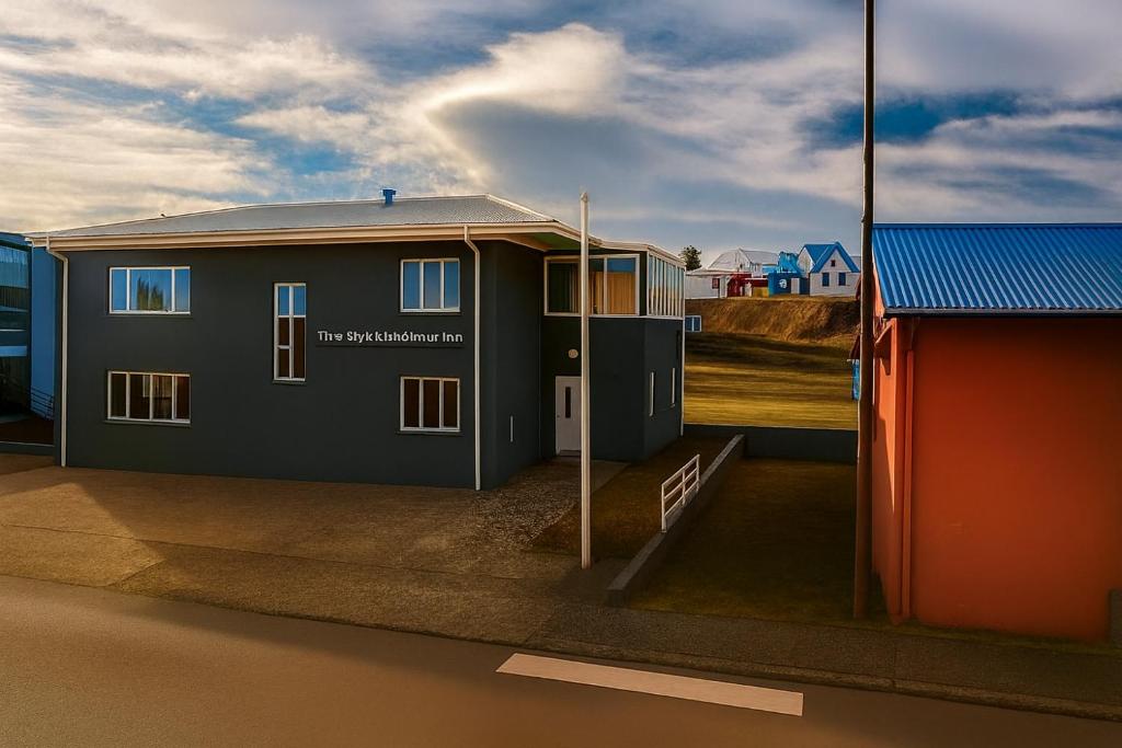 a small house with a red and blue building at The Stykkishólmur Inn by Ourhotels in Stykkishólmur