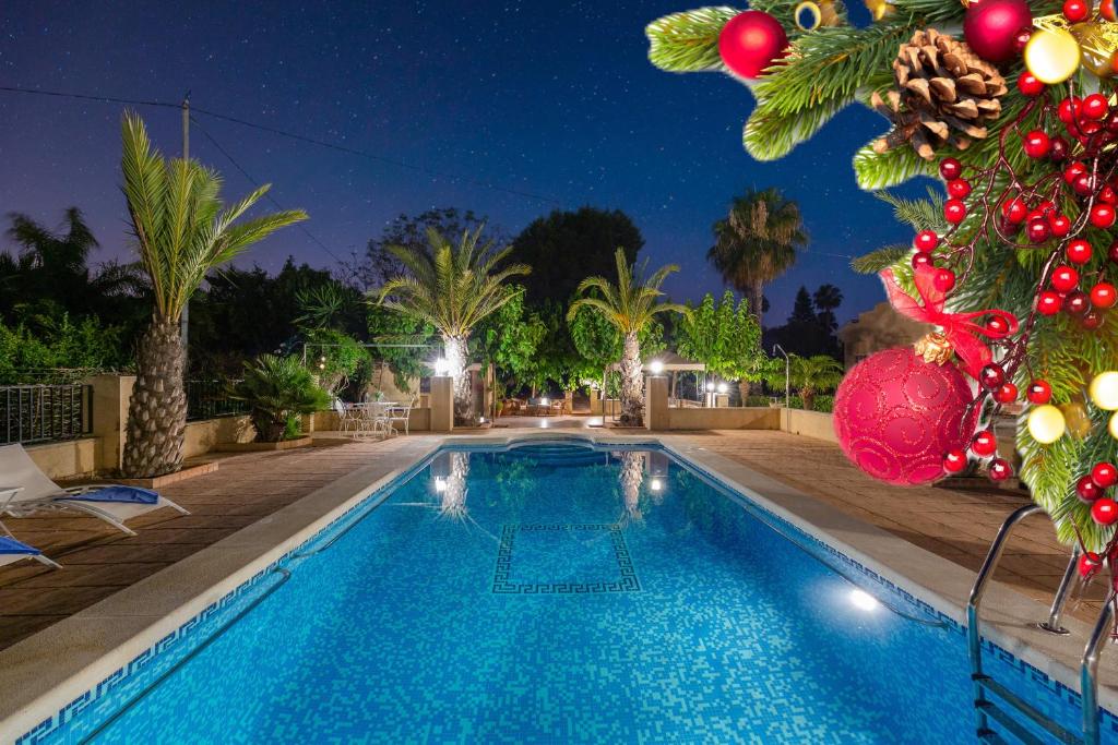 a swimming pool with a christmas tree next to it at Harmony Villa by Fidalsa in Daya Vieja
