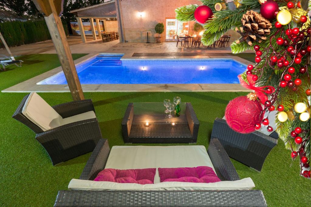 a swimming pool with a christmas tree in front of it at SunnyValley by Fidalsa in Dolores