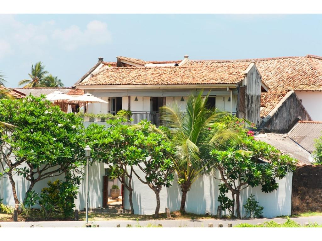 a white house with trees in front of it at Pool, Roof Terrace, 3 Bedroom Villa, Galle Fort in Galle