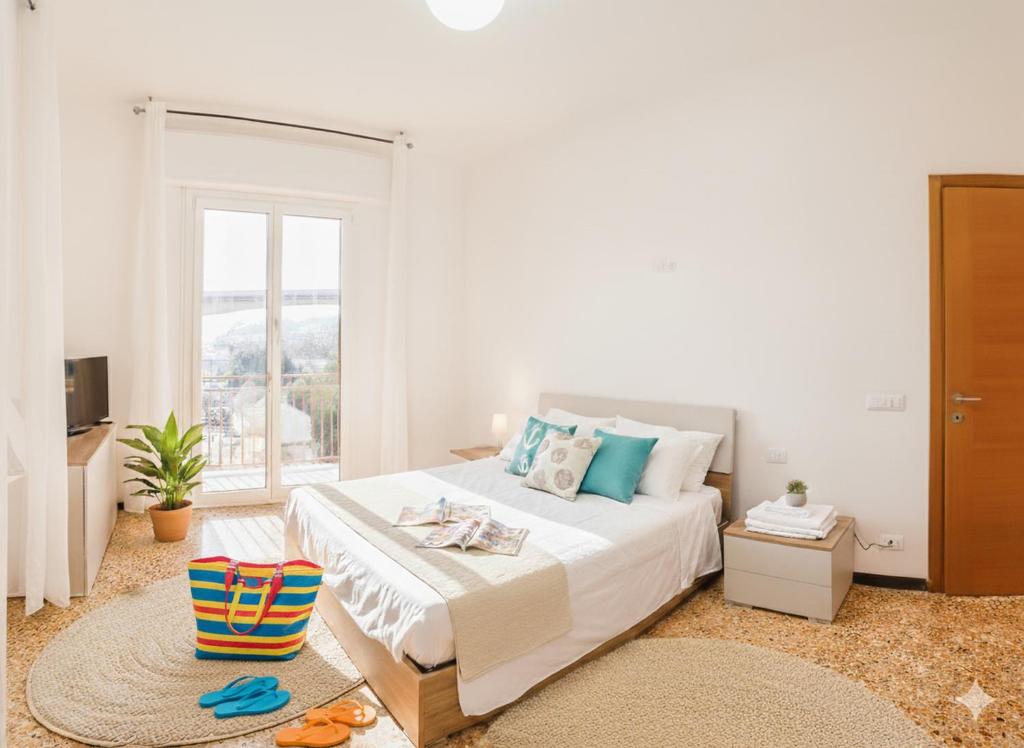 een slaapkamer met een groot bed en een raam bij Perla d'aMare in San Lorenzo al Mare