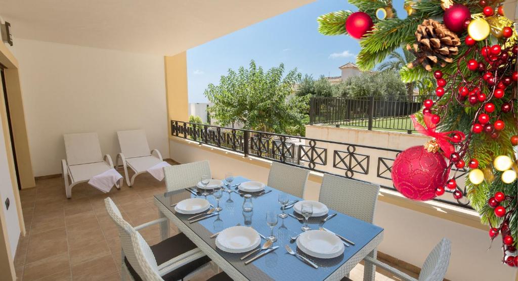 a dining table with a christmas tree on a balcony at Fidalsa Guardamar Resort in El Moncayo