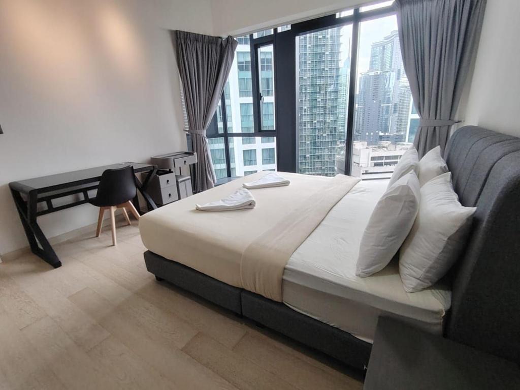a bedroom with a large bed with a large window at Star Infinity Pool At Klcc in Kuala Lumpur