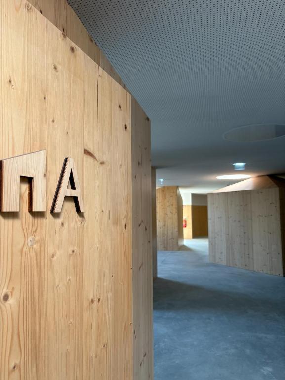 a wall with the word tla on it in an office building at Angeiras Beach Hostel in Lavra