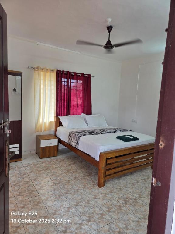 Un dormitorio con una cama y una ventana en New Paradise Inn, en Varkala