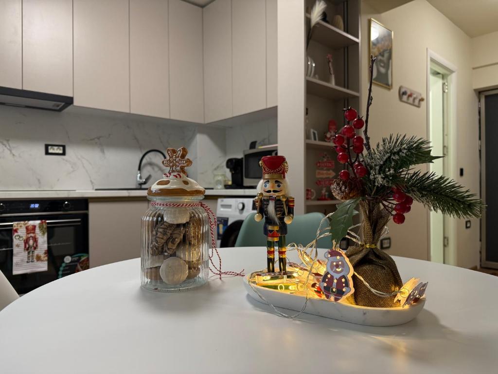a table with christmas decorations on it in a kitchen at Aristizza Studio in Craiova