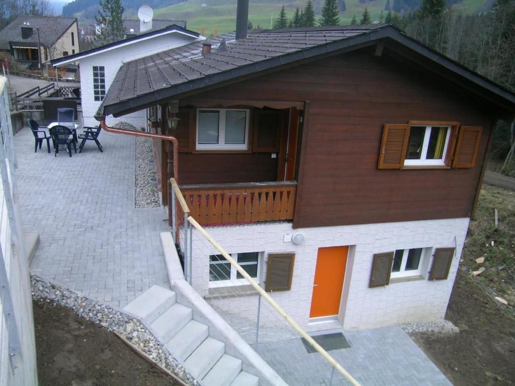 a small house with a porch and a patio at Ferienwohnung Monya in Sörenberg