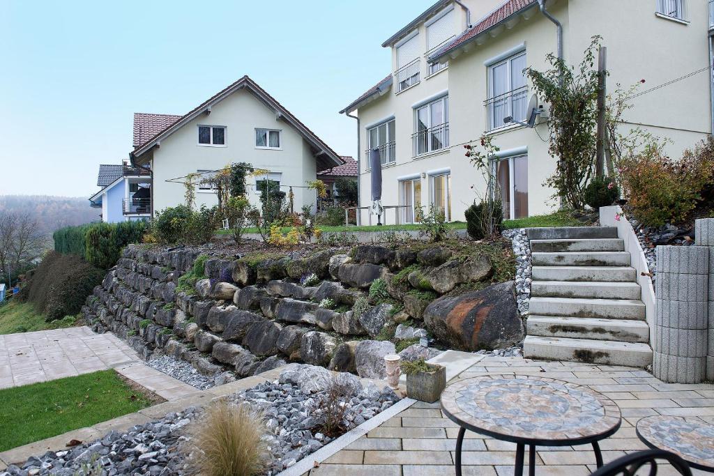 a stone retaining wall in front of a house at Ferienwohnung Talblick in Kalkofen